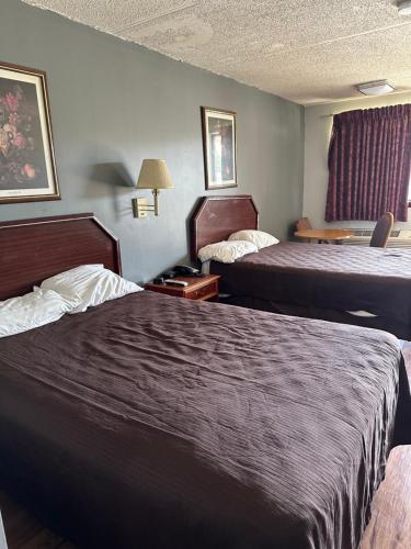 a hotel room with two beds in a room at Budget Inn-Gadsden in Gadsden