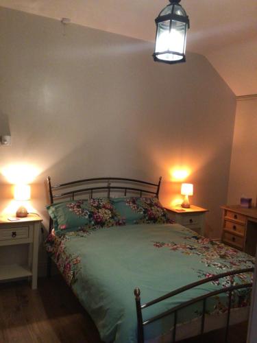 a bedroom with a bed with two night stands and two lamps at Mary's in Selby