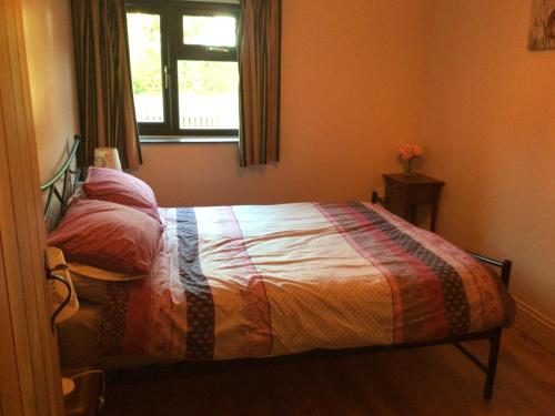 a bedroom with a bed with a window and a window at Sycamore, Moss Hagg Farm in Selby