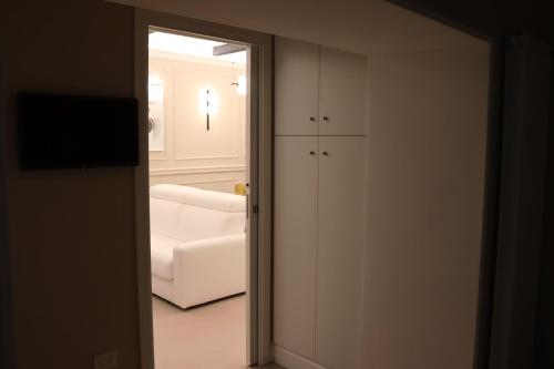 an open door to a living room with a white couch at SUITE 38 in Campagnano di Roma