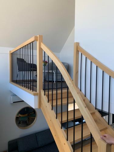 a wooden staircase in a living room with a couch at Rybical 42 in Rybical