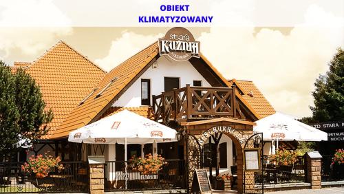 a building with a sign on top of it at Stara Kuźnia Mazurska in Węgorzewo