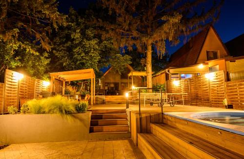 a house with a swimming pool at night at Körös-parti Terasz Vendégház in Békésszentandrás