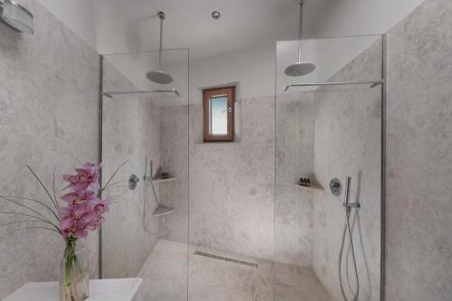a bathroom with a shower with a vase of flowers at Sakali Mansion in Pinakátai