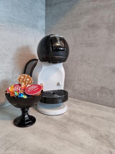 a coffee maker with a bowl of candy at Apartment near center / free P in Ålesund
