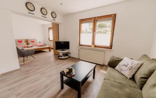 a living room with a couch and a table at Ferienhaus Scheid in Bremm