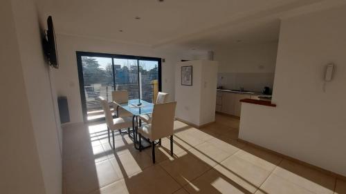 a kitchen and dining room with a table and chairs at La Maruca 631 in Balcarce
