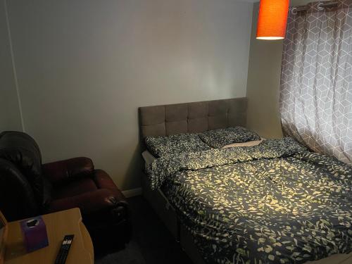 a small bedroom with a bed and a chair at 1 bedroom in 3bed house in Bristol