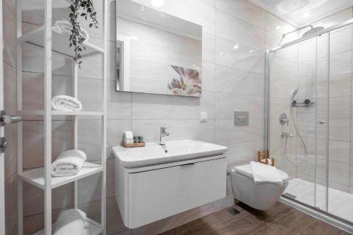 a white bathroom with a sink and a shower at Bovilla Hotel Yalıkavak in Yalıkavak