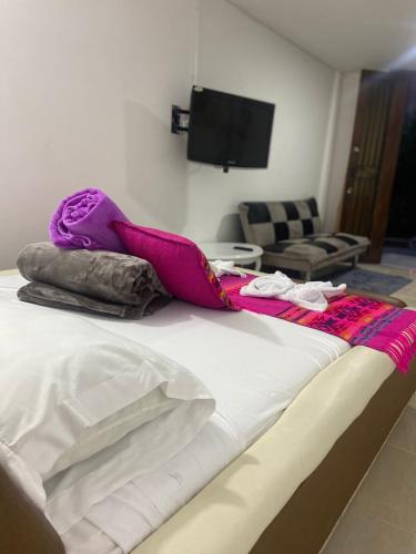 a bed with blankets and pillows on top of it at Mi Balconcito in Salento