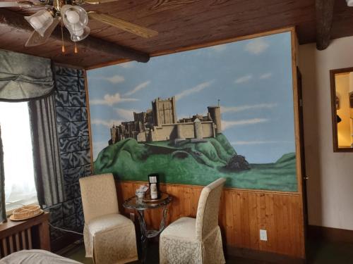 a room with a painting of a castle on the wall at The King George Inn in Cobourg