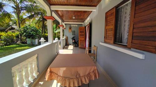 a porch of a house with a table on it at Villa Ste Marie in Sainte Marie