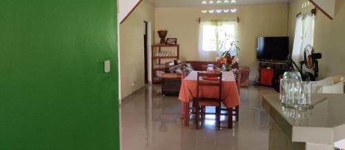 a living room with a table and a green wall at Villa Ste Marie in Sainte Marie