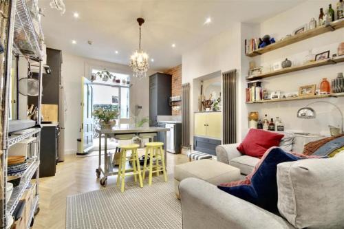 a living room with a couch and a table at A charming home in the heart of Southsea in Portsmouth