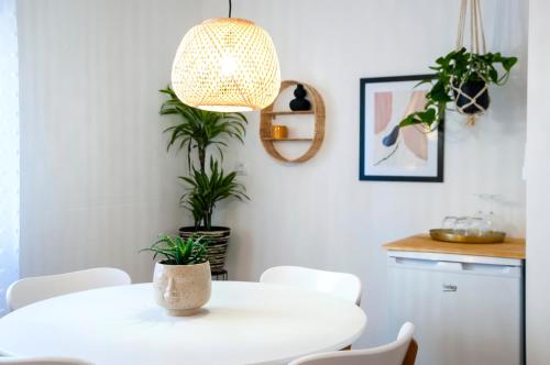 a dining room with a white table and plants at bed&breakfast Bohemian in Rovinj