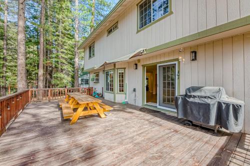 a wooden deck with a picnic table next to a house at Montgomery Estates Ski & Beach Haven in South Lake Tahoe