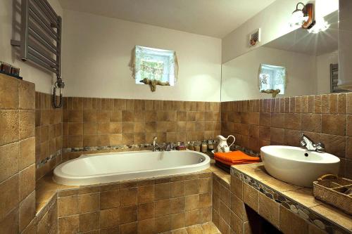 a large bathroom with a tub and a sink at Holiday home in an idyllic location in Debki in Dębki