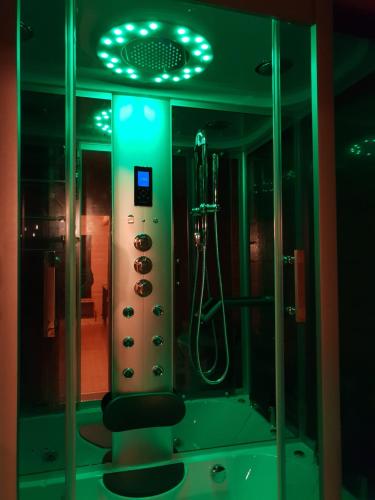 a bathroom with a shower with a sink and a shower at Caban Cwtch - Log fire, pool table, hot tub cinema in Kent