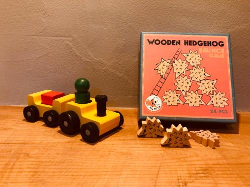 a toy train on a table next to a book at 天然温泉つきの ちいさな貸別荘 little villa 柊日 in Azumino
