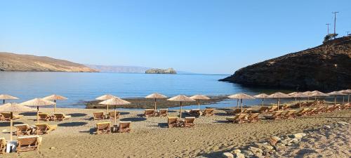 a group of chairs and umbrellas on a beach at Paradise in Kollimpithra