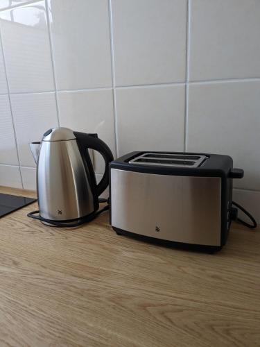 a toaster and a toaster oven sitting on a kitchen floor at Ruhiges Ferienhaus mit Sauna: Hellaberg III in Langenbach