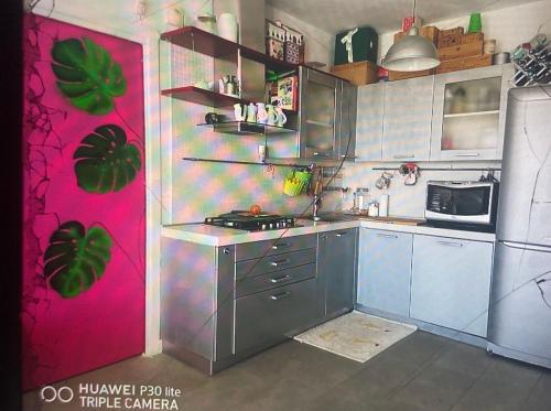 a kitchen with a stove and a refrigerator at Lagoon Hause - Residenza Del Sole in Maddalenedda