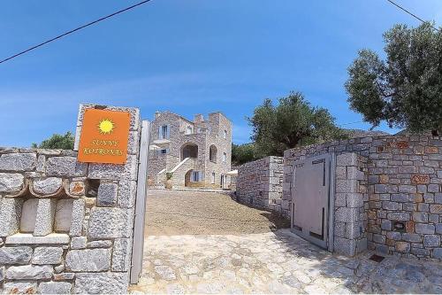 a stone building with a sign in front of it at Sunny Kotronas in Kótronas