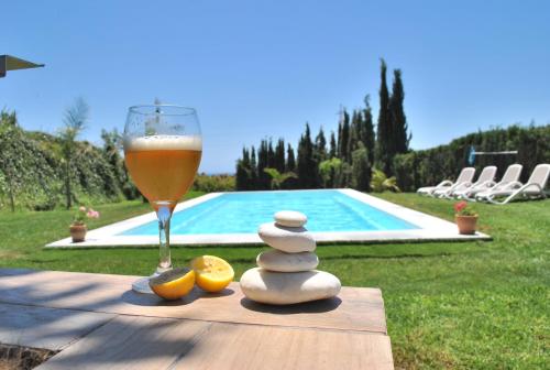 un vaso de cerveza junto a una pila de piedras y una bebida en Villa Monica, en Nerja