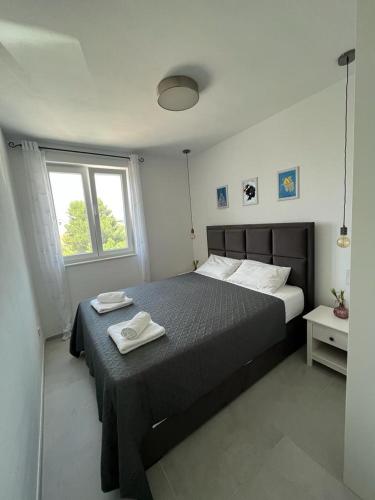 a bedroom with a bed with two towels on it at Haus Dalmatia with heated Pool in Bibinje
