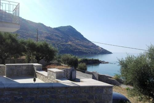 a view of a body of water with a mountain at Sunny Kotronas in Kótronas
