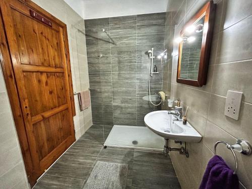 a bathroom with a sink and a shower at Galileo Rooms in Il- Gżira