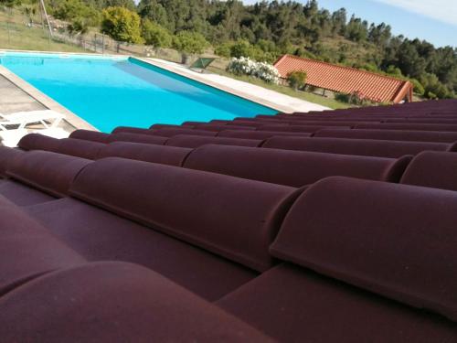 a swimming pool with brown seats in a stadium at Quinta Do Quetrofe in Guarda