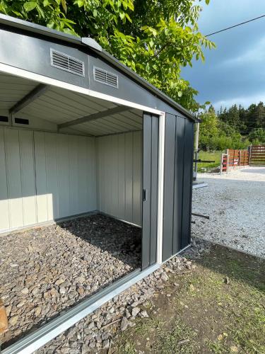 a garage with a large sliding glass door at Wellness chalupa Soběšice - brána na Šumavu in Soběšice