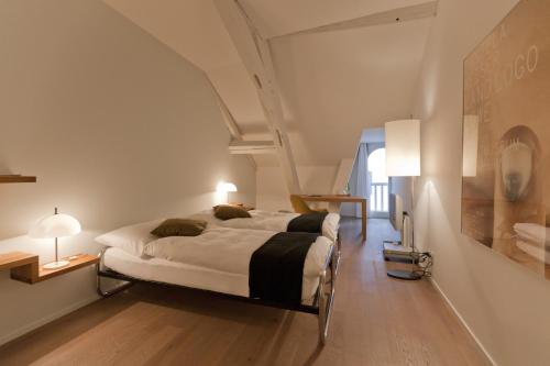 a bedroom with a large bed in a room at Baseltor Hotel & Restaurant in Solothurn