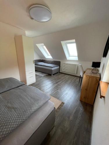 a bedroom with a bed and a couch at Wellness chalupa Soběšice - brána na Šumavu in Soběšice