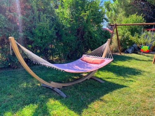 a hammock sitting in the grass in a yard at Ivonnis Garden in Mesimvría