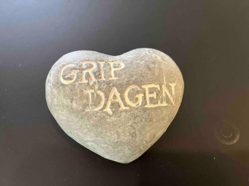 a heart shaped stone with the words php dagen written on it at Leilighet ved sjøkanten in Langevåg