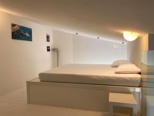 a bedroom with a bed and a glass table at Loft Trabocco - Dimora dei Portici in Ortona