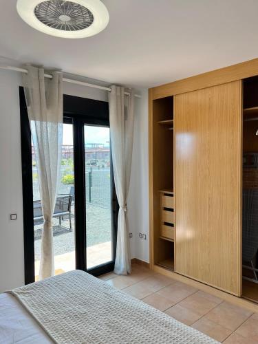 a bedroom with a bed and a large window at Villa Do Juano in Lajares