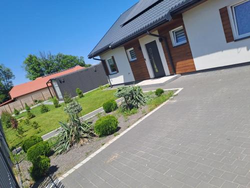 a house with a driveway in front of it at Apartament Roztocze in Zamość
