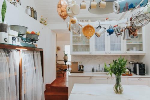 a kitchen with a table and some pots and pans at Senhora do Cabo Meco Homy Holidays in Sesimbra