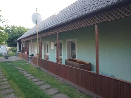 a green house with a fence next to it at Domček v Turnej in Trenčianska Turná