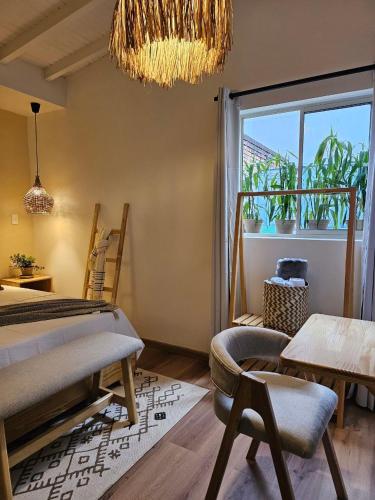 a bedroom with a bed and a window and a chandelier at Luum Boutique hotel in Medellín
