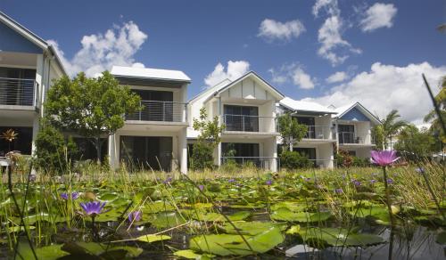 a lotus pond in front of houses at Ivory Palms Resort Noosa in Noosaville