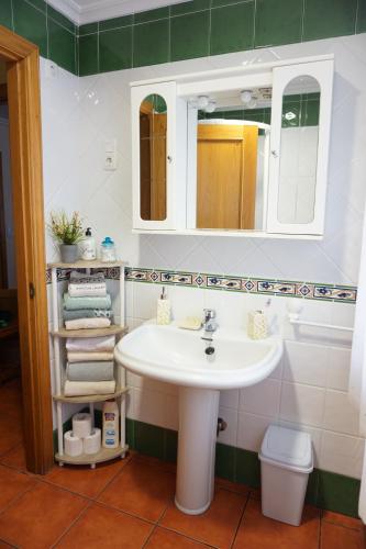 a bathroom with a sink and a mirror at Hermanas Iglesias in O Vicedo