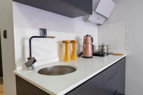 a kitchen counter with a sink and a appliance at Yusufhan Suites in Trabzon