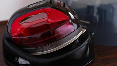 a red motorcycle helmet sitting on top of a table at Dormy Inn Takamatsu in Takamatsu