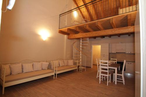 a living room with a couch and a loft at Agriturismo Cascina della Fontana in Lodi