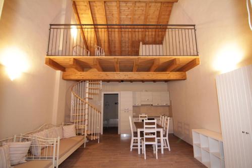 a room with a staircase and a table and chairs at Agriturismo Cascina della Fontana in Lodi