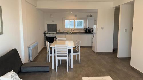 a kitchen and dining room with a table and chairs at Las Acacias Tandil in Tandil